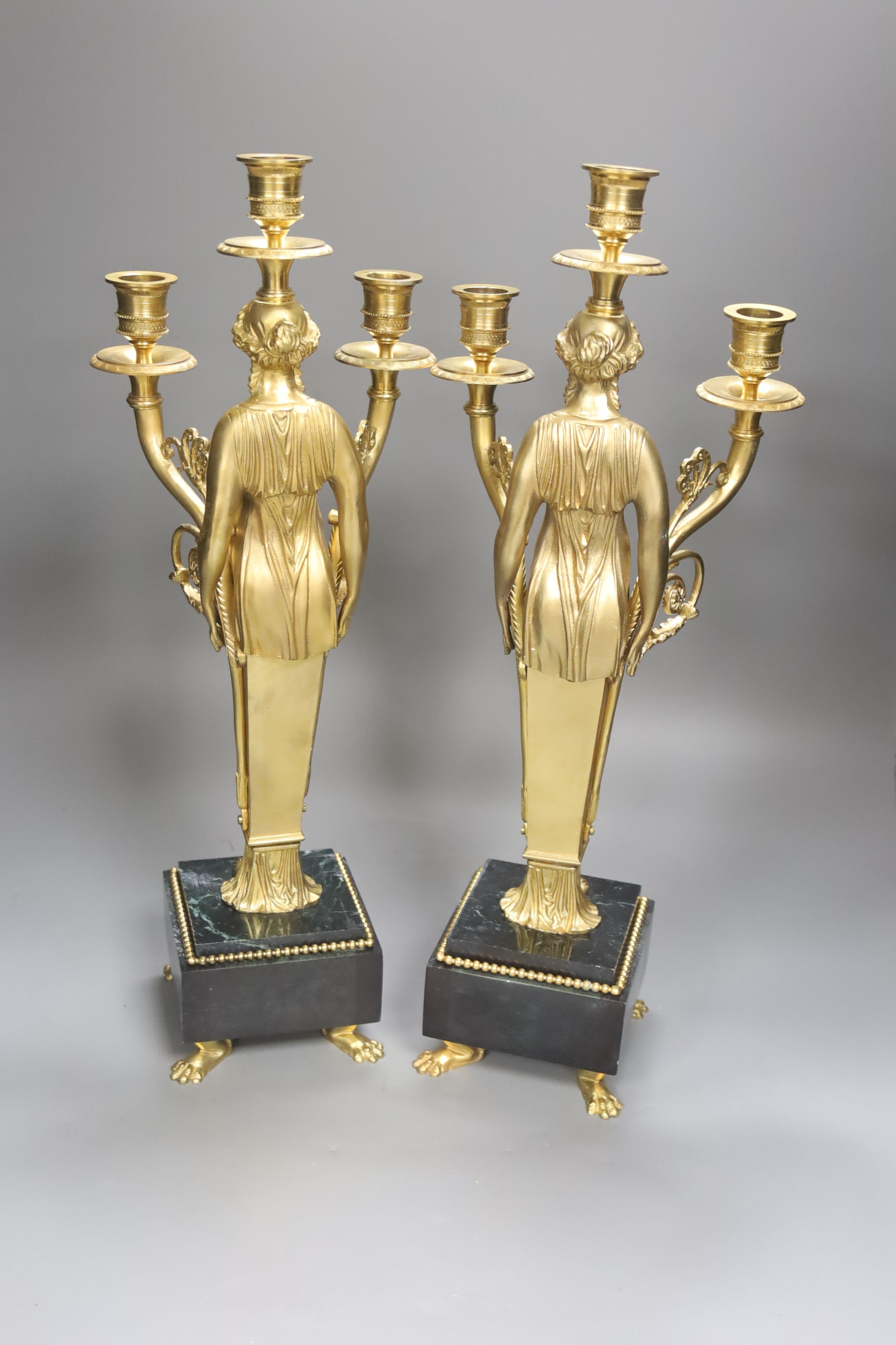 A pair of neo-classical style gilt metal figural candelabra, height 45cm